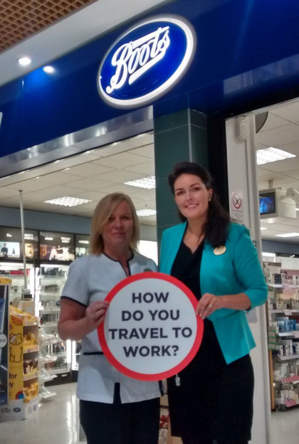 Staff and manager from chemist Boots with Travel sign